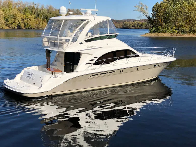 Slide: The Image of 2006 Sea Ray 52 Sedan Bridge yacht on a calm river. - 5