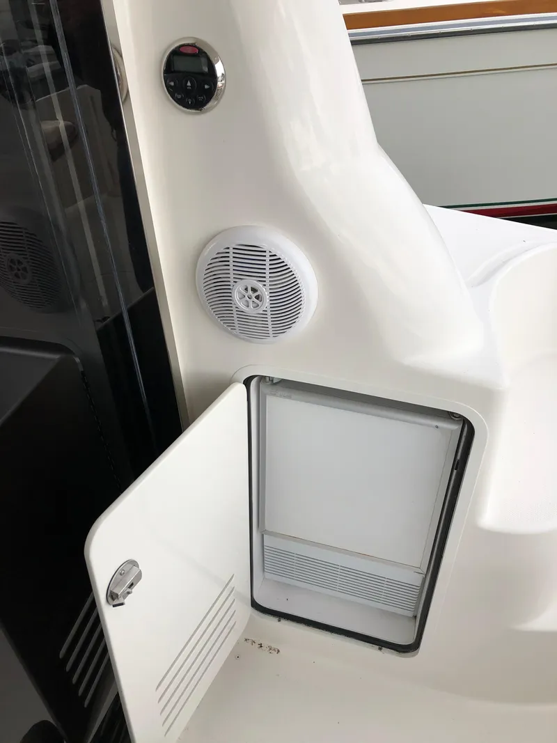 Slide: The Image of 2006 Sea Ray 52 Sedan Bridge boat interior with open storage compartment and speaker. - 8