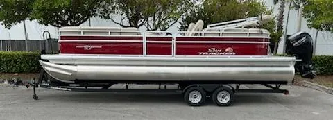 The Image of 2024 Sun Tracker Party Barge 24 DLX pontoon boat on a trailer, side view. - 0