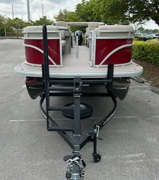 Slide: The Image of 2024 Sun Tracker Party Barge 24 DLX pontoon boat on a trailer. - 2