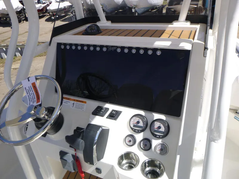 Slide: The Image of 2024 Ranger 2360 Bay boat dashboard with steering wheel and gauges. - 11