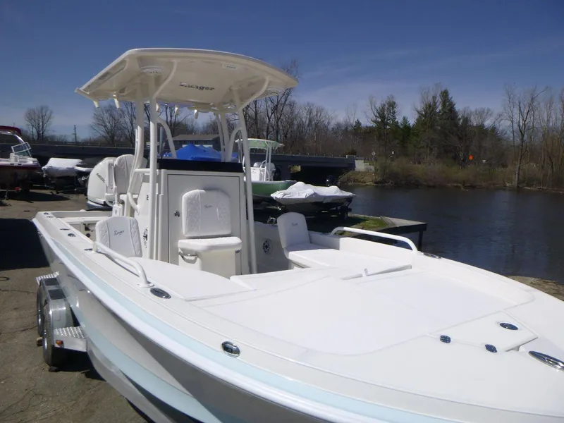 Slide: The Image of 2024 Ranger 2360 Bay boat docked by a serene river. - 16