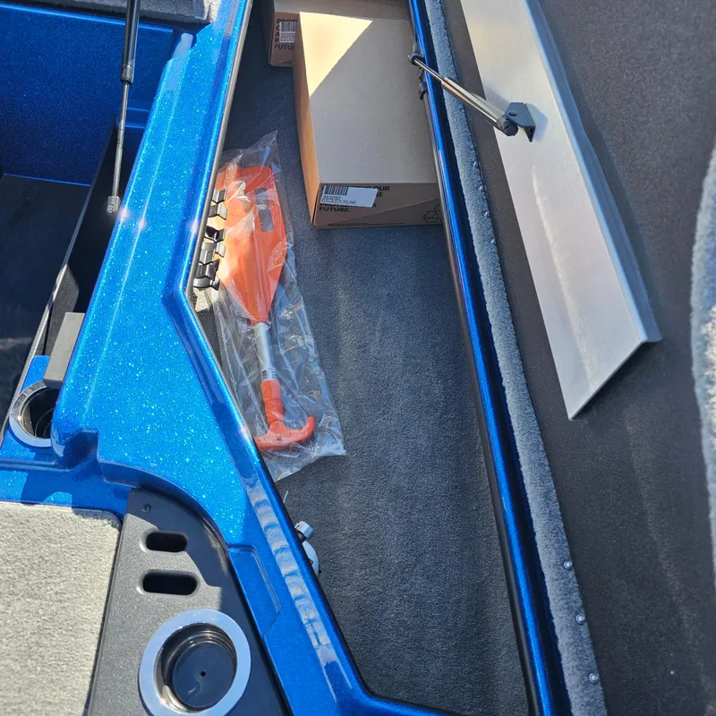 Slide: The Image of Storage compartment of 2024 Nitro Z18 Pro boat with safety equipment and cardboard box. - 10