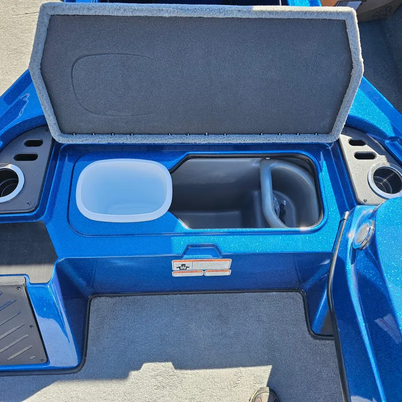 Slide: The Image of 2024 Nitro Z18 Pro boat storage compartment with open lid and cup holders. - 12