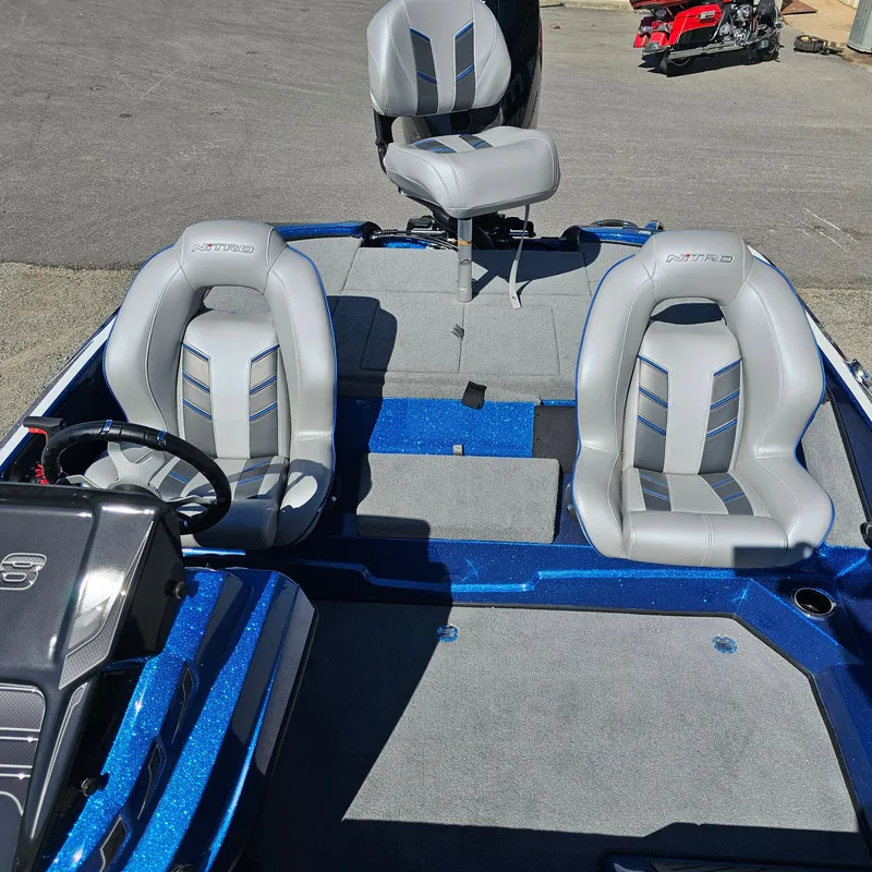 Slide: The Image of 2024 Nitro Z18 Pro boat interior with three gray seats and blue accents. - 13
