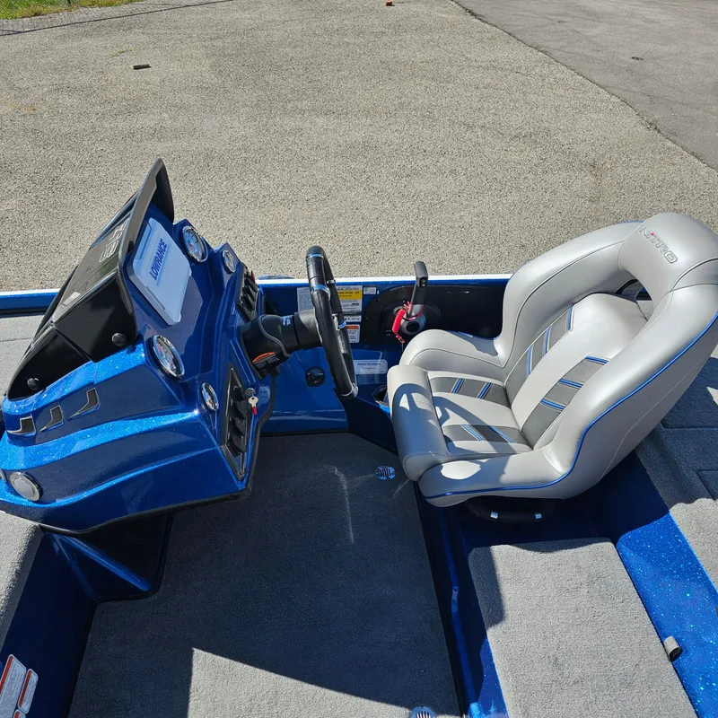 Slide: The Image of 2024 Nitro Z18 Pro boat cockpit with steering wheel and cushioned seat. - 14