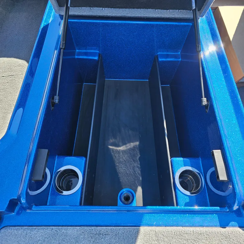 Slide: The Image of 2024 Nitro Z18 Pro boat storage compartment with blue interior and cup holders. - 7