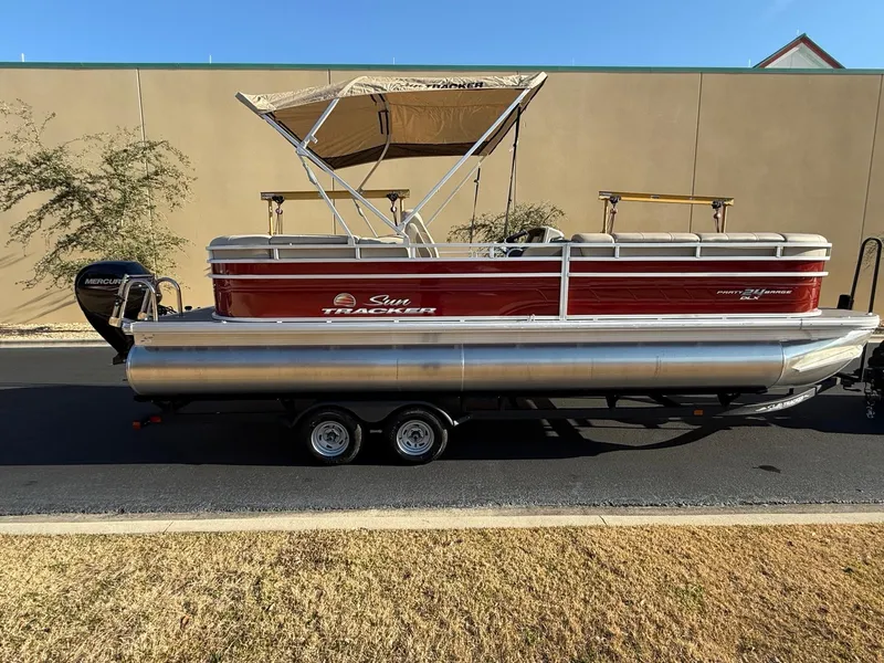 The Image of 2024 Sun Tracker Party Barge 24 DLX pontoon boat on trailer, side view. - 0