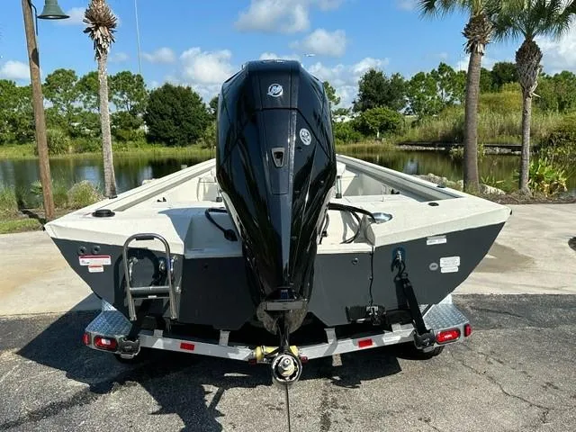 Slide: The Image of 2024 Ranger RB210 boat with powerful outboard motor, parked near a scenic lake. - 3