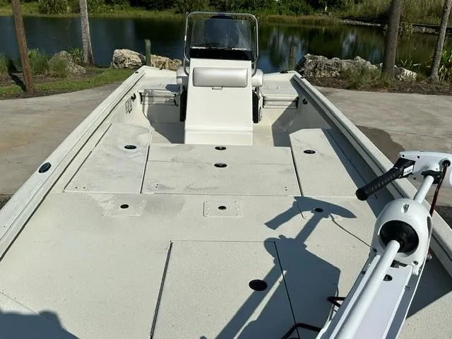 Slide: The Image of 2024 Ranger RB210 boat with spacious deck and trolling motor, near a serene lake. - 5