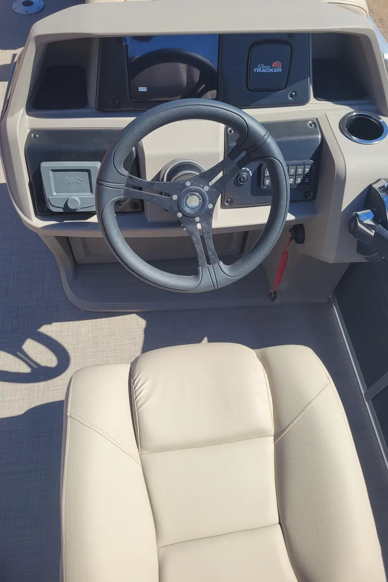 Slide: The Image of 2024 Sun Tracker Party Barge 24 DLX helm with steering wheel and captain's chair. - 4