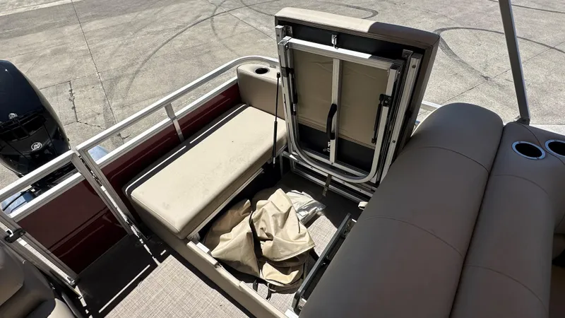 Slide: The Image of 2024 Sun Tracker Party Barge 24 DLX interior with storage compartment open. - 5