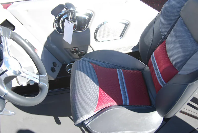 Slide: The Image of 2024 Ranger 620FS Pro boat cockpit with steering wheel and red-gray seat. - 11
