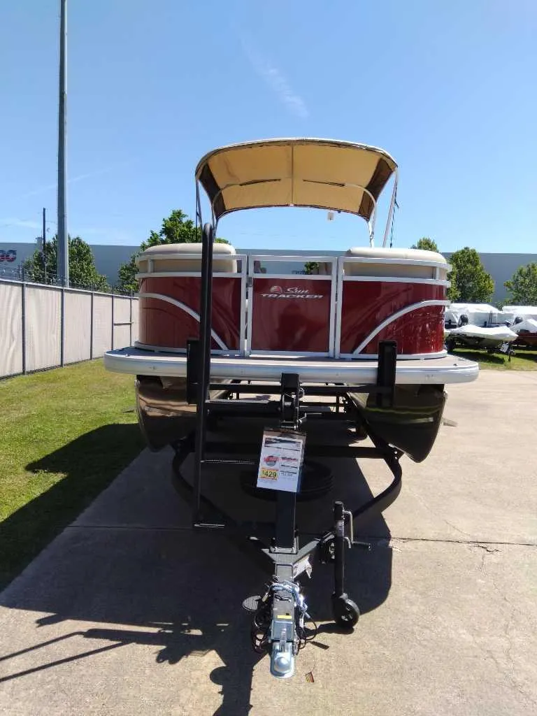 Slide: The Image of 2024 Sun Tracker Party Barge 24 DLX pontoon boat on a trailer. - 2