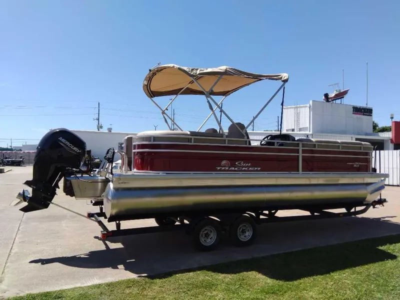 Slide: The Image of 2024 Sun Tracker Party Barge 24 DLX pontoon boat with canopy on trailer. - 4