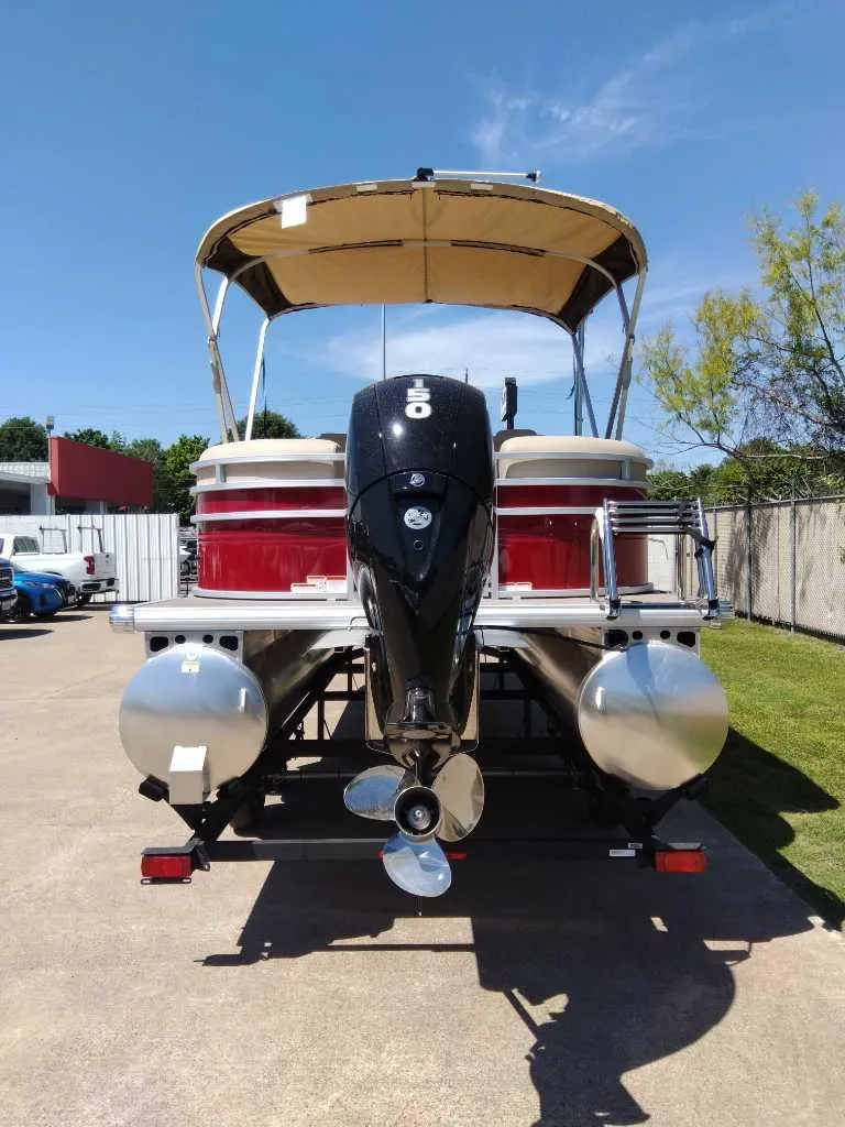 Slide: The Image of 2024 Sun Tracker Party Barge 24 DLX pontoon boat, rear view with outboard motor. - 5