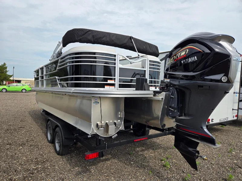 Slide: The Image of 2023 SunCatcher Elite 322 RC pontoon boat with Yamaha motor, parked on a trailer. - 1