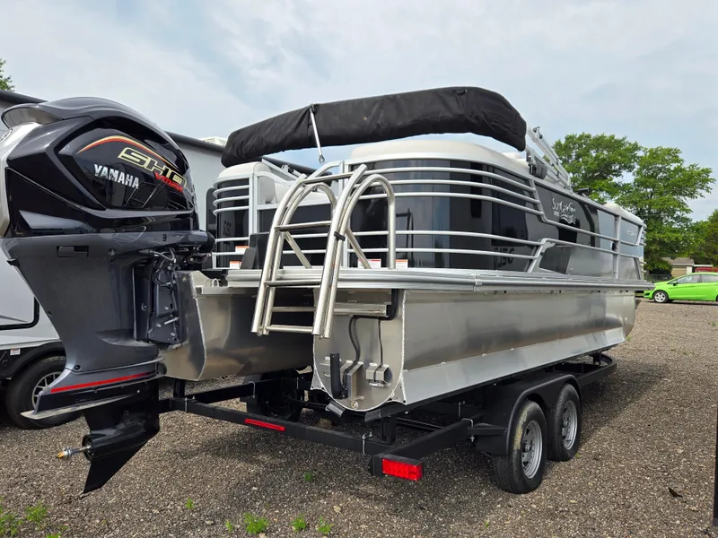 Slide: The Image of 2023 SunCatcher Elite 322 RC pontoon boat with Yamaha engine on trailer. - 3