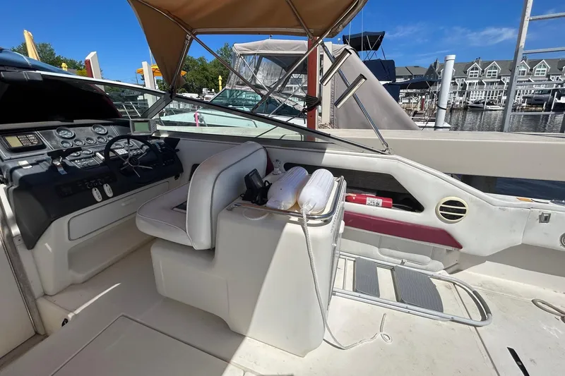 Slide: The Image of 1992 Sea Ray 280 Weekender boat interior with helm and seating area. - 10