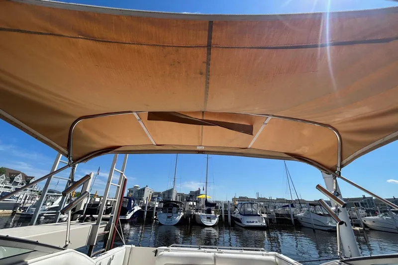 Slide: The Image of View from a 1992 Sea Ray 280 Weekender under a canopy at a marina. - 11