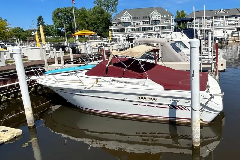 Slide: The Image of 1992 Sea Ray 280 Weekender boat docked at a marina with red canopy. - 13