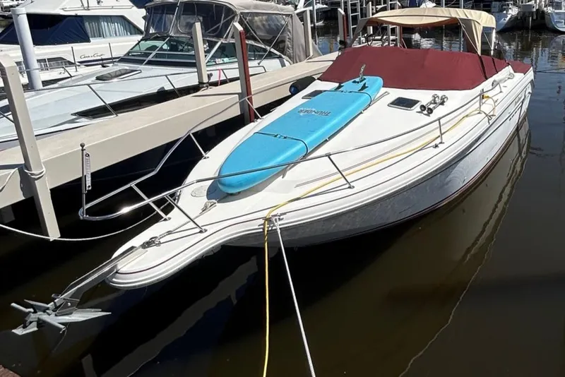 Slide: The Image of 1992 Sea Ray 280 Weekender docked with a blue paddleboard on deck. - 15