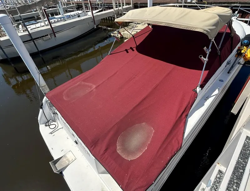 Slide: The Image of 1992 Sea Ray 280 Weekender with red canvas cover docked at marina. - 16