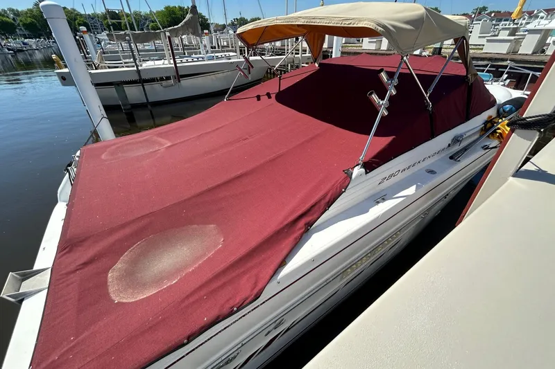 Slide: The Image of 1992 Sea Ray 280 Weekender boat docked with red cover. - 17