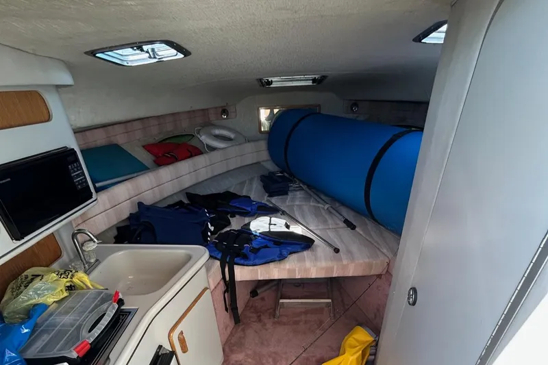 Slide: The Image of Interior cabin of a 1992 Sea Ray 280 Weekender boat with various equipment. - 18