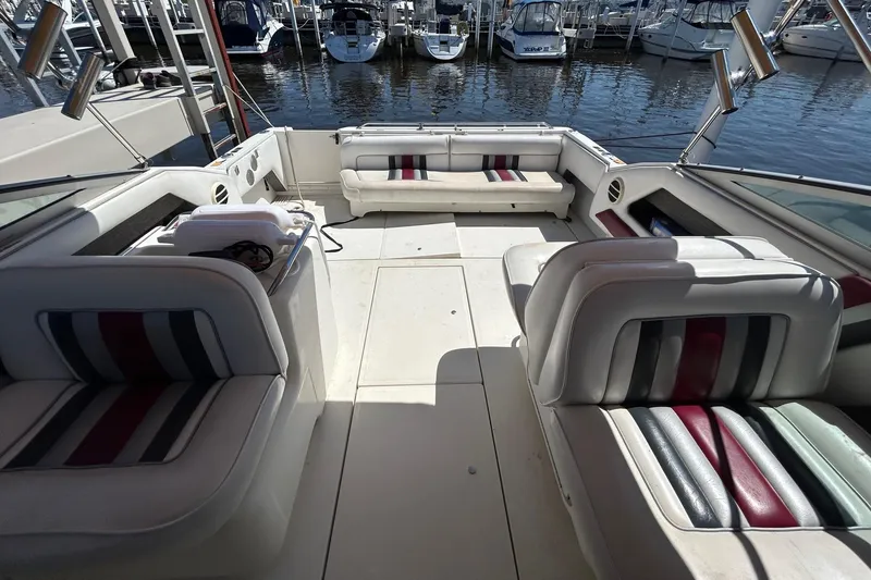 Slide: The Image of 1992 Sea Ray 280 Weekender boat interior with striped seating at marina. - 4