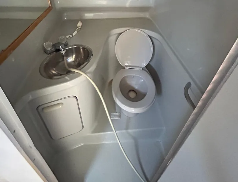 Slide: The Image of Compact bathroom in 1992 Sea Ray 280 Weekender boat with toilet and sink. - 6