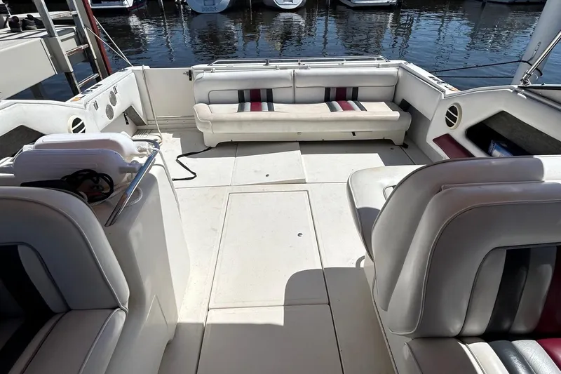 Slide: The Image of 1992 Sea Ray 280 Weekender boat interior with white seating and waterfront view. - 7
