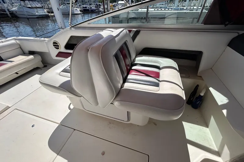 Slide: The Image of 1992 Sea Ray 280 Weekender boat interior with cushioned seating and marina view. - 9