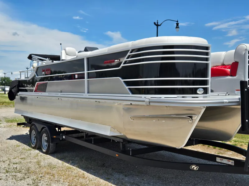 Slide: The Image of 2024 SunCatcher Elite 326 SS pontoon boat on trailer, sleek black and silver design. - 2