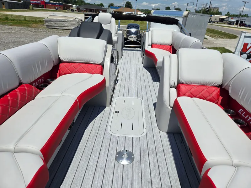 Slide: The Image of 2024 SunCatcher Elite 326 SS boat interior with red and white seating, spacious layout. - 7