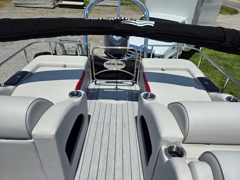 Slide: The Image of 2024 SunCatcher Elite 326 SS boat interior with plush seating and cup holders. - 8