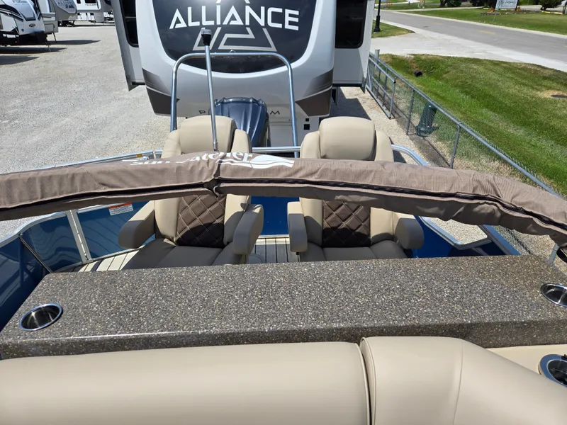 Slide: The Image of 2024 SunCatcher Elite 326 SE boat interior with beige seating and granite-style counter. - 9