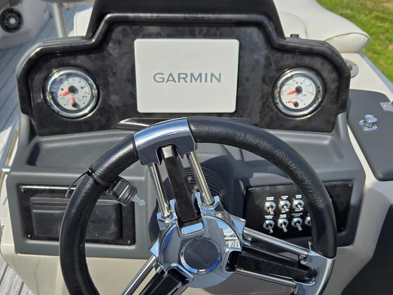 Slide: The Image of 2024 SunCatcher Elite 326 SL boat dashboard with Garmin display and gauges. - 10