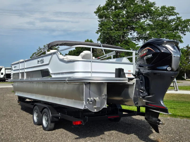 Slide: The Image of 2024 SunCatcher Elite 326 SL pontoon boat with Yamaha motor on trailer. - 2
