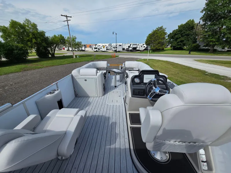Slide: The Image of 2024 SunCatcher Elite 326 SL pontoon boat with luxurious seating and modern dashboard. - 7