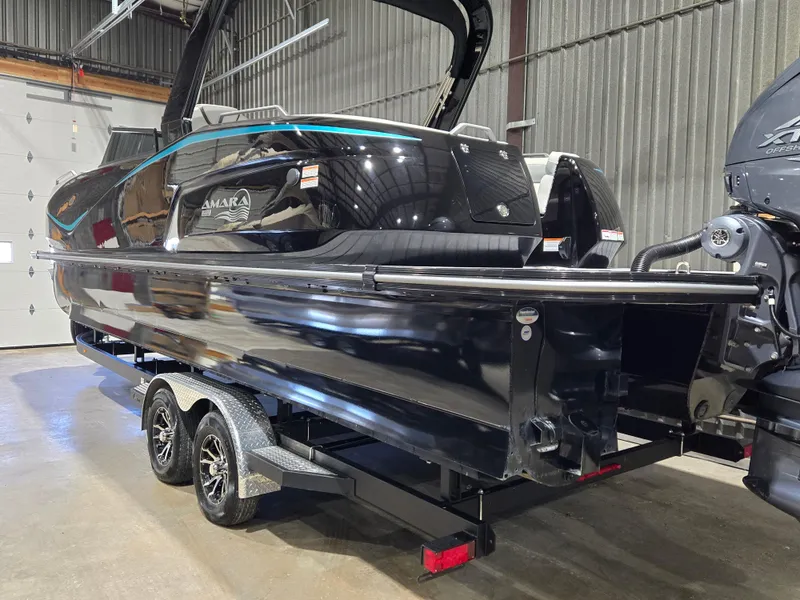 Slide: The Image of 2024 SunCatcher Amara boat on trailer in warehouse setting. - 2