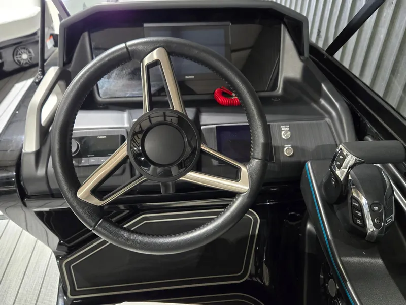 Slide: The Image of 2024 SunCatcher Amara boat dashboard with steering wheel and control panel. - 9
