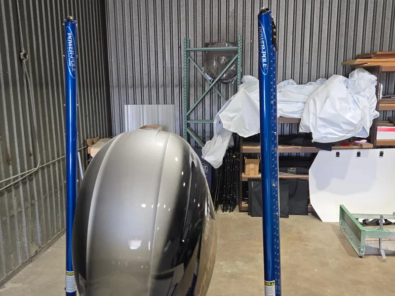 Slide: The Image of 2023 G3 Bay 20 GX boat in storage with blue Power-Pole anchors. - 14