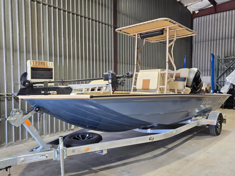 Slide: The Image of 2023 G3 Bay 20 GX boat on trailer in storage facility. - 2