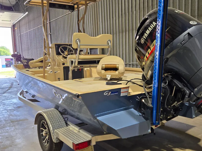 Slide: The Image of 2023 G3 Bay 20 GX boat with Yamaha motor in a garage setting. - 3