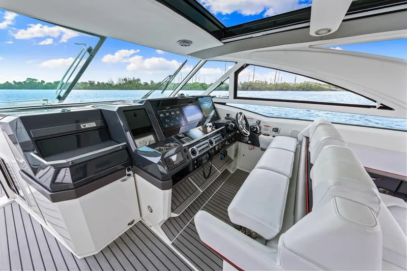 Slide: The Image of 2017 Formula 430 Super Sport Crossover yacht cockpit with modern controls and white seating. - 35