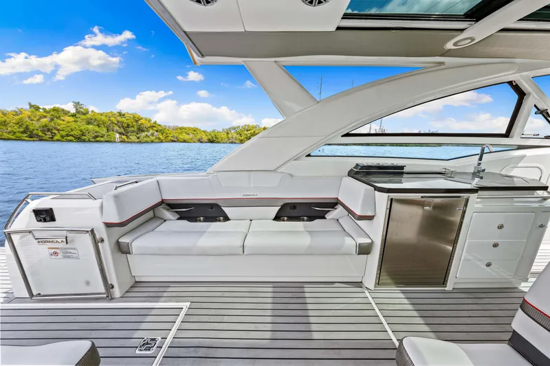 Slide: The Image of 2017 Formula 430 Super Sport Crossover yacht interior with seating and kitchenette. - 40