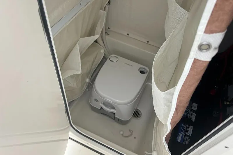 Slide: The Image of 2024 Key West 219 FS boat interior with portable toilet. - 19