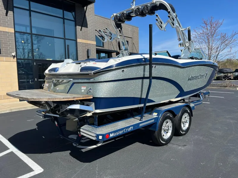 Slide: The Image of 2016 MasterCraft X23 boat on a trailer in a parking lot. - 3