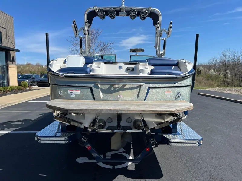 Slide: The Image of 2016 MasterCraft X23 boat rear view in parking lot. - 4